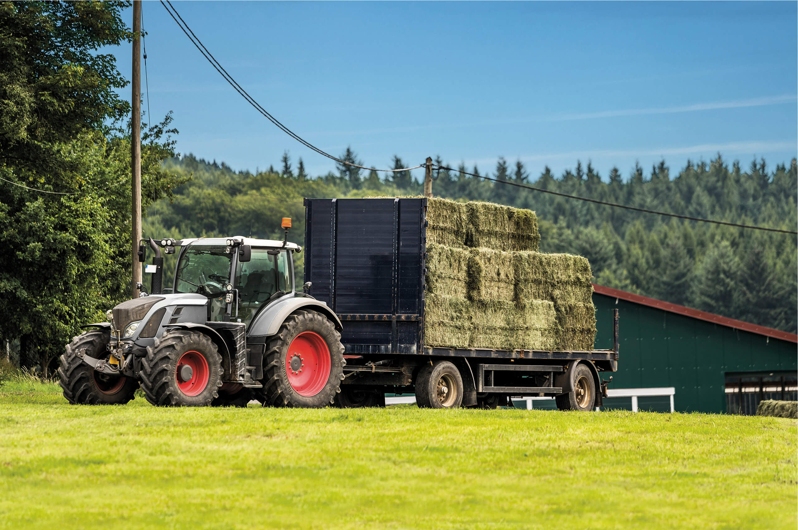 a tractor transports bales